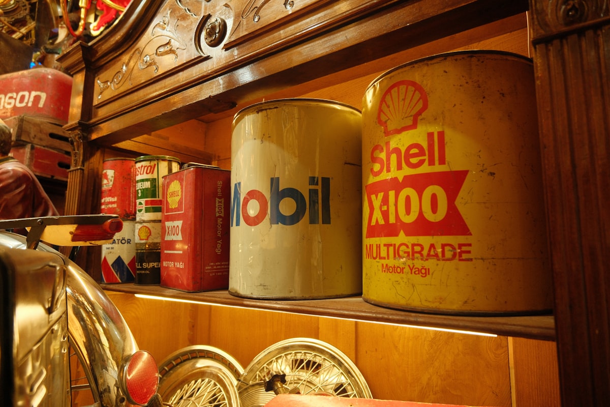 Vintage motor oil cans on a workshop shelf