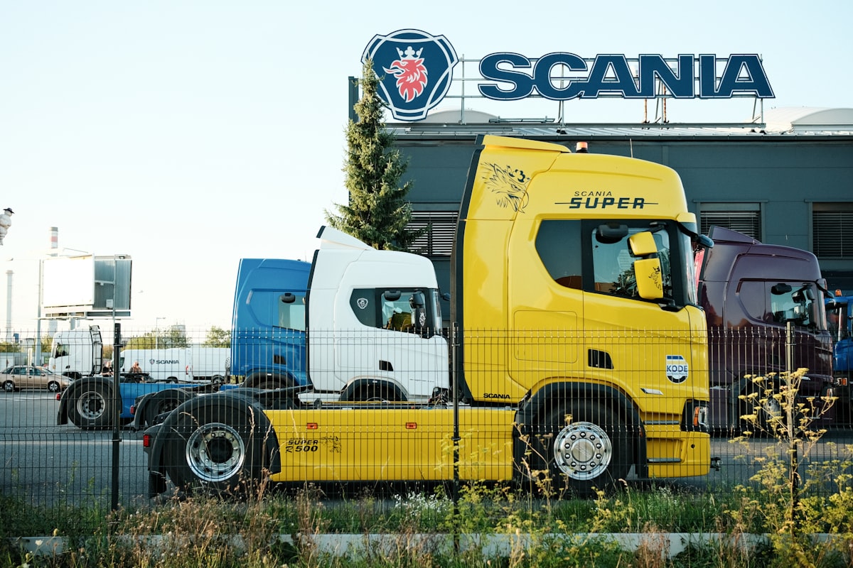 Row of commercial trucks at a Scania depot